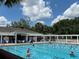 Enjoy swimming in this community's pool, surrounded by palm trees and a charming clubhouse at 1305 Guerra Ave, The Villages, FL 32159