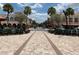 A charming downtown street view with shops and dining, plus lush trees and a spacious sidewalks at 1305 Guerra Ave, The Villages, FL 32159