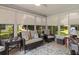 Cozy sunroom with comfortable seating, large windows, and natural light at 1305 Guerra Ave, The Villages, FL 32159