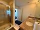 Bright bathroom featuring a glass shower, granite countertop with double sinks, and an opening to the bedroom at 155 S Court Ave # 1801, Orlando, FL 32801