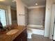 Well-lit bathroom featuring a tiled shower and bathtub combination and a granite countertop vanity at 155 S Court Ave # 1801, Orlando, FL 32801