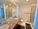 Bathroom featuring a glass shower, granite countertop with double sinks, large mirror, and tile flooring at 155 S Court Ave # 1801, Orlando, FL 32801