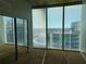 Bedroom with mirrored closet, plush carpeting and a large window offering a scenic city view at 155 S Court Ave # 1801, Orlando, FL 32801