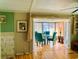 Elegant dining area with green chairs and French doors leading to a sunroom, perfect for entertaining guests at 201 Jacaranda Dr, Leesburg, FL 34748