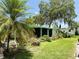 Beautiful home exterior with lush landscaping and a covered porch at 201 Jacaranda Dr, Leesburg, FL 34748