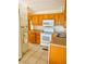 Functional kitchen with white appliances and light wood cabinets at 201 Jacaranda Dr, Leesburg, FL 34748