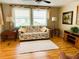 Cozy living room with hardwood floors and comfortable seating at 201 Jacaranda Dr, Leesburg, FL 34748