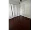 Bedroom with a ceiling fan, white walls, dark wood-look floor, and closet space at 2013 Dixie Belle Dr # 2013K, Orlando, FL 32812