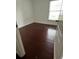 Clean bedroom with a dark wood-look floor and window providing ample natural light at 2013 Dixie Belle Dr # 2013K, Orlando, FL 32812