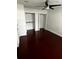 Neutral bedroom with hardwood floors, ceiling fan, and closet storage at 2013 Dixie Belle Dr # 2013K, Orlando, FL 32812