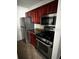 Kitchen with stainless steel appliances and cherry wood cabinets at 2013 Dixie Belle Dr # 2013K, Orlando, FL 32812