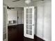 Open-concept living room with white walls, dark wood-look floors, and bright sunlight at 2013 Dixie Belle Dr # 2013K, Orlando, FL 32812