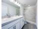 Modern bathroom featuring double sinks, granite countertops, and a tiled walk-in shower at 2117 Emma Ln, Lake Wales, FL 33898