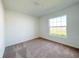 Bright bedroom featuring plush carpeting and ample natural light from a large window at 2117 Emma Ln, Lake Wales, FL 33898