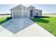 Charming single-story home featuring a two-car garage and freshly sodded front lawn at 2117 Emma Ln, Lake Wales, FL 33898