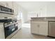 Modern kitchen featuring stainless steel appliances, granite countertops, and tile flooring at 2117 Emma Ln, Lake Wales, FL 33898