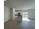 Bright, open kitchen with white cabinets, stainless steel appliances, and an island overlooking the living area at 2117 Emma Ln, Lake Wales, FL 33898