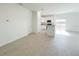 Bright and airy living room with tile flooring and an open floor plan leading to the kitchen at 2117 Emma Ln, Lake Wales, FL 33898