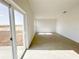 Bright living room featuring tile flooring, a large sliding glass door, and ample natural light at 2117 Emma Ln, Lake Wales, FL 33898