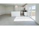 Open-concept living room and kitchen area with tile flooring and natural light at 2117 Emma Ln, Lake Wales, FL 33898