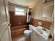 A vintage bathroom with pink and brown tiles features a bathtub and vanity at 2216 Weber St, Lakeland, FL 33801