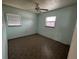 This bedroom features a ceiling fan and two windows that provide natural light at 2216 Weber St, Lakeland, FL 33801