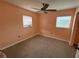 Small peach-colored bedroom with two windows letting in natural light at 2216 Weber St, Lakeland, FL 33801