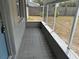 Screened porch with tile flooring, offering a cozy outdoor space at 2216 Weber St, Lakeland, FL 33801