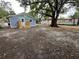 View of the backyard showing the newly constructed deck and a glimpse of the surrounding neighborhood at 2217 Azalea Ct, Lakeland, FL 33815