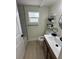 Bathroom with modern vanity, decorative shelves, and neutral walls at 2217 Azalea Ct, Lakeland, FL 33815