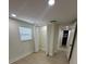 A well lit bedroom includes an open closet, laminate flooring, and bright window at 2217 Azalea Ct, Lakeland, FL 33815