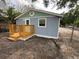 Charming exterior featuring light blue paint, a cozy wooden porch, and a newly installed door at 2217 Azalea Ct, Lakeland, FL 33815