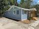 Charming blue house with a freshly painted exterior and well-manicured yard at 2217 Azalea Ct, Lakeland, FL 33815