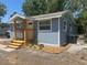 Charming renovated home with blue siding, a welcoming porch, and new landscaping at 2217 Azalea Ct, Lakeland, FL 33815