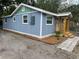 Side view of the home, featuring a new porch, fresh mulch, and updated windows at 2217 Azalea Ct, Lakeland, FL 33815