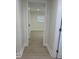 Hallway view of the bedroom, featuring hardwood floors and fresh paint at 2217 Azalea Ct, Lakeland, FL 33815