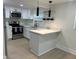 Updated kitchen features stainless steel appliances, sleek white cabinetry, and modern lighting at 2217 Azalea Ct, Lakeland, FL 33815