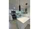 Beautiful kitchen with white cabinets, stainless appliances, and modern pendant lighting at 2217 Azalea Ct, Lakeland, FL 33815