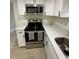 Kitchen featuring stainless steel appliances, white cabinets, and modern countertops at 2217 Azalea Ct, Lakeland, FL 33815