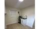 Neutral laundry room with laminate floors and utility sink at 2217 Azalea Ct, Lakeland, FL 33815
