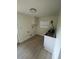 The laundry room has vinyl flooring, hookups, a sink, and white upper cabinets at 2217 Azalea Ct, Lakeland, FL 33815