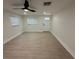 Bright living room with modern wood-look flooring, and a contemporary ceiling fan at 2217 Azalea Ct, Lakeland, FL 33815