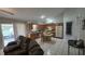 Open-concept kitchen featuring a center island, tile floors, and an adjacent living area at 303 Silk Oak Dr, Kissimmee, FL 34743