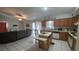 Open-concept kitchen featuring a center island, tile floors, and adjacent living space at 303 Silk Oak Dr, Kissimmee, FL 34743