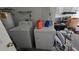 Functional laundry room equipped with a washer, dryer, and storage shelving at 303 Silk Oak Dr, Kissimmee, FL 34743