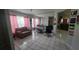 Bright living room with tile floors, comfortable seating and a mirrored wall for added spaciousness at 303 Silk Oak Dr, Kissimmee, FL 34743