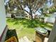 Landscaped backyard showing single story homes and mature trees at 313 Palo Verde Dr, Leesburg, FL 34748