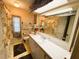 Bathroom with a shower-tub combination, toilet, single sink vanity, and large mirror at 313 Palo Verde Dr, Leesburg, FL 34748