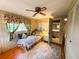 Cozy bedroom with wood flooring, ceiling fan, and ensuite bathroom access at 313 Palo Verde Dr, Leesburg, FL 34748