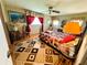 Bedroom featuring wood flooring, a window with red curtains, and decor at 313 Palo Verde Dr, Leesburg, FL 34748